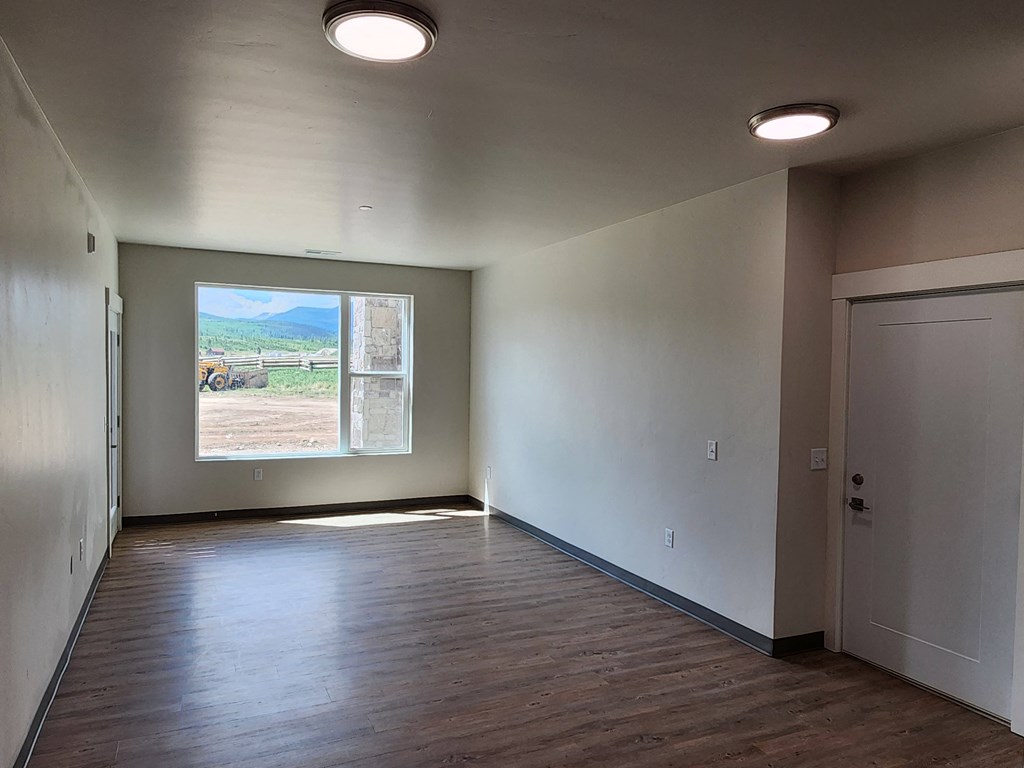 an empty room with a window and a door