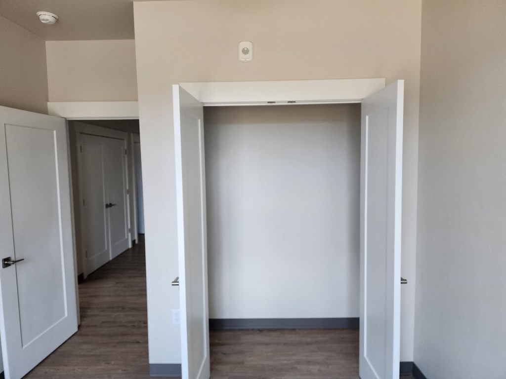 a living room with white walls and a wooden floor