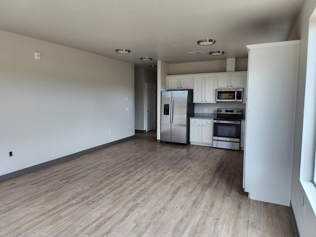 an empty kitchen and living room in an apartment