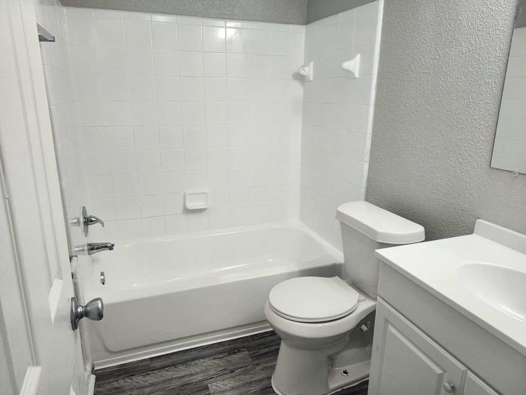 an empty bathroom with a toilet and a bath tub