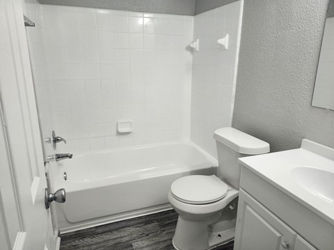 an empty bathroom with a toilet and a bath tub