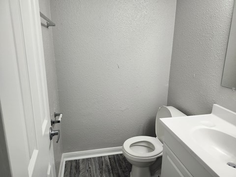 an empty bathroom with a toilet and a sink