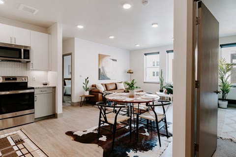 A modern kitchen with a dining table set for four.