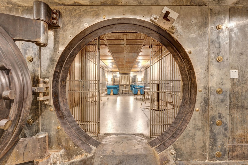 a large metal door in a room with tables and chairs at Metro67, Memphis