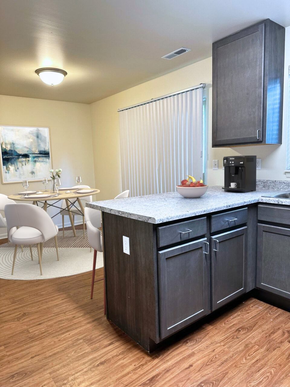 A kitchen with a table and chairs.