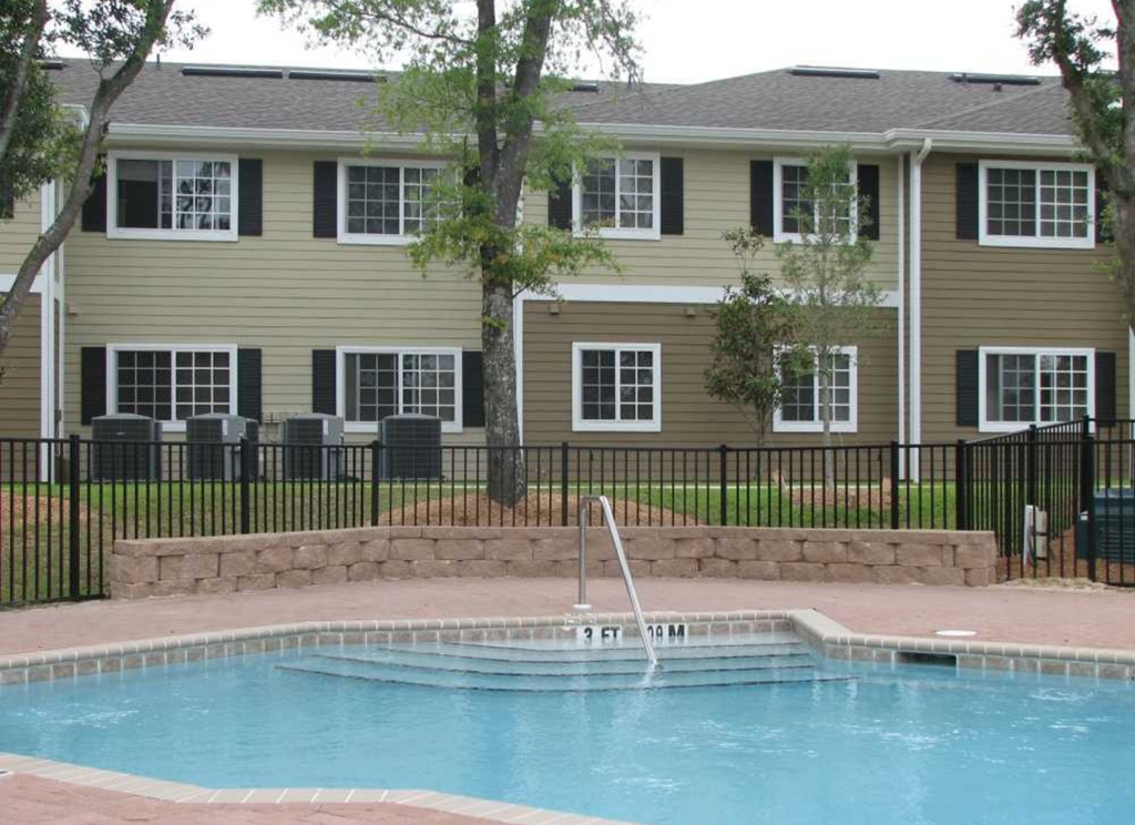 a swimming pool in front of an apartment building