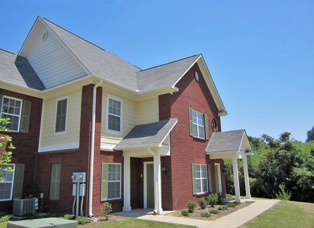 a red brick house with white columns