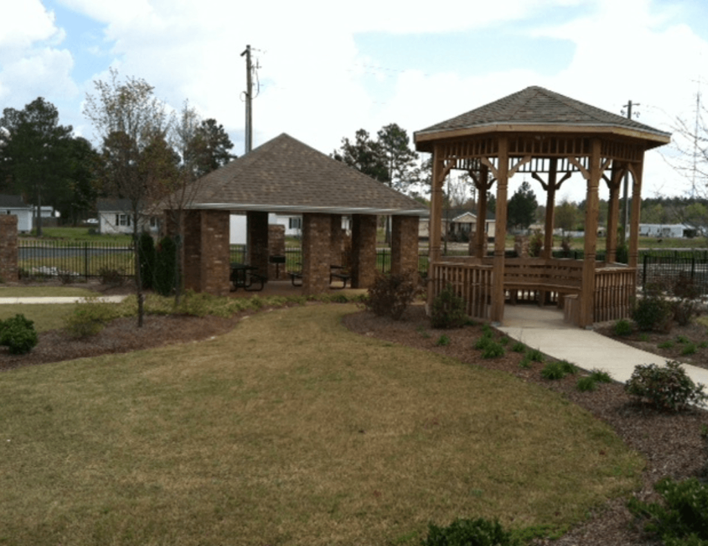 a gazebo and picnic area in a park