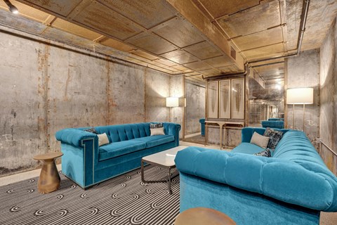 a living room with blue couches and a black and white carpet at Metro67, Tennessee, 38103