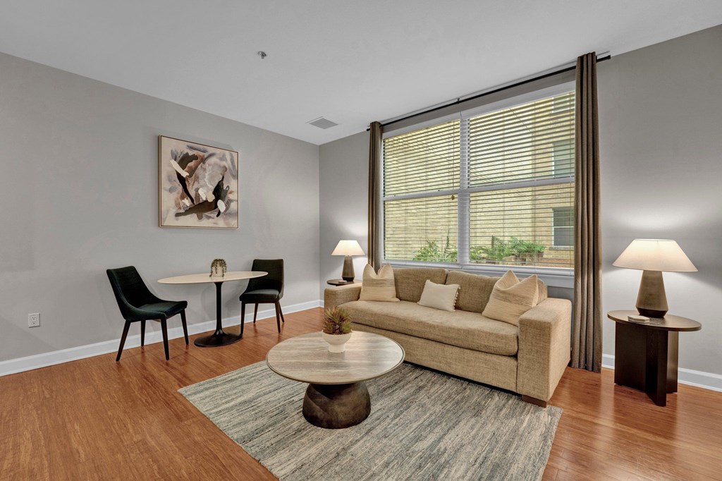 A living room with a couch, chairs, and a coffee table.