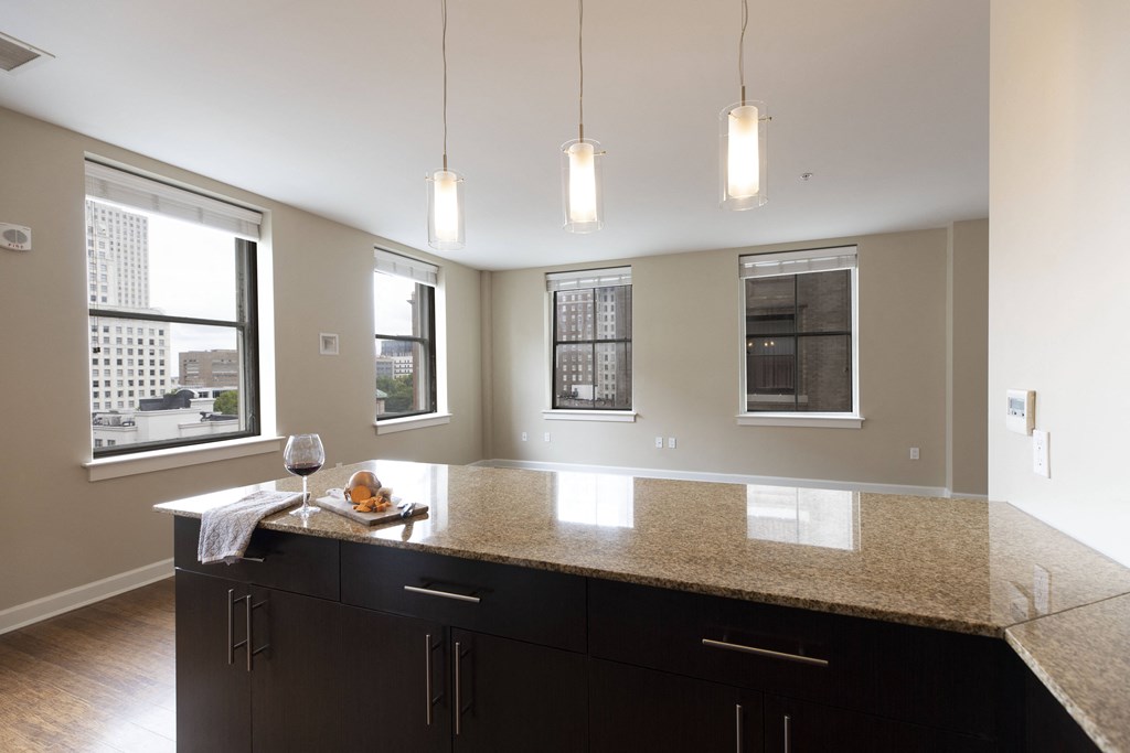 a kitchen with a large island with granite countertops at Metro67, Memphis, TN, 38103