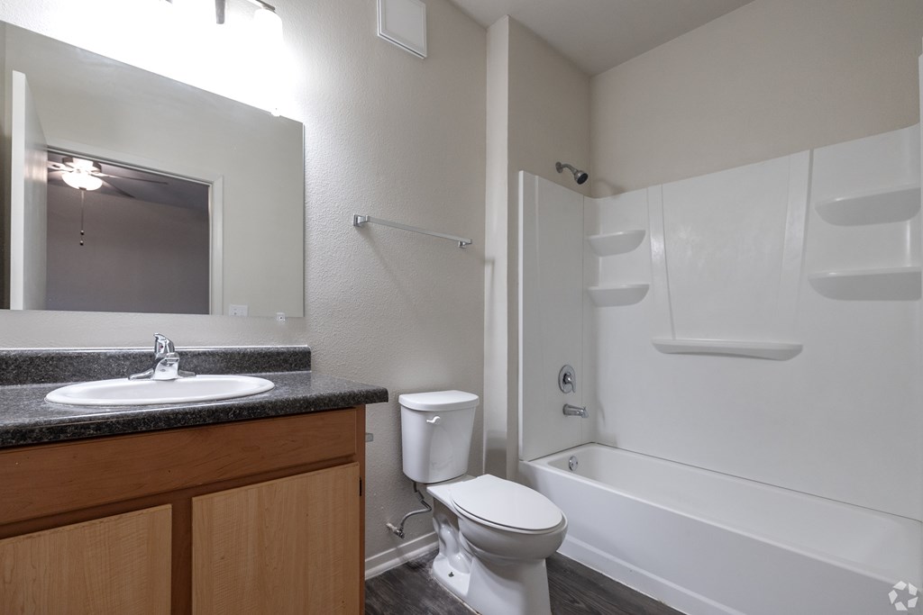 A white toilet is next to a sink in a small bathroom.