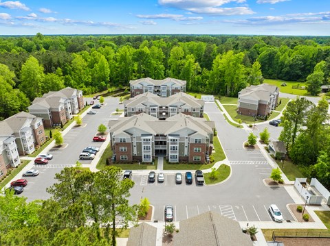 A bird's eye view of a residential area with houses and cars.