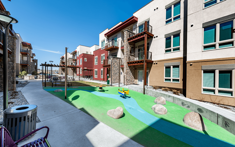 a view of a playground in the middle of an apartment building