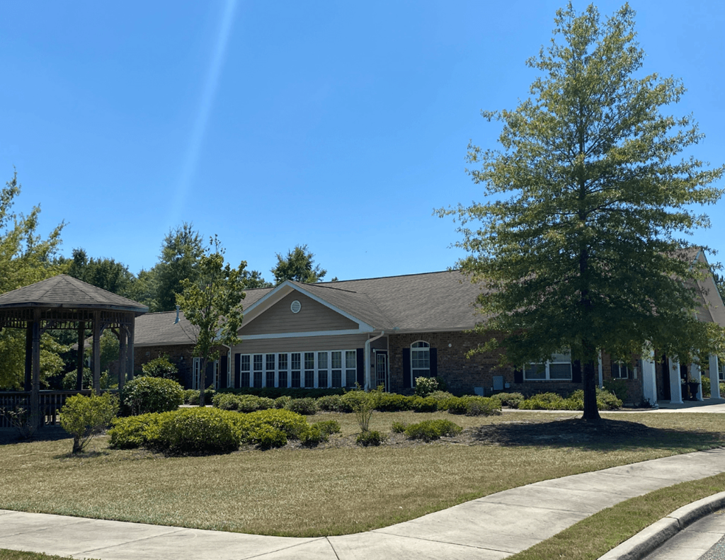 a house with a gazebo and a tree