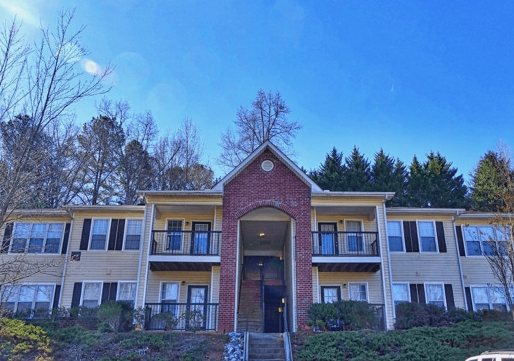a view of an apartment building with a blue sky in the background