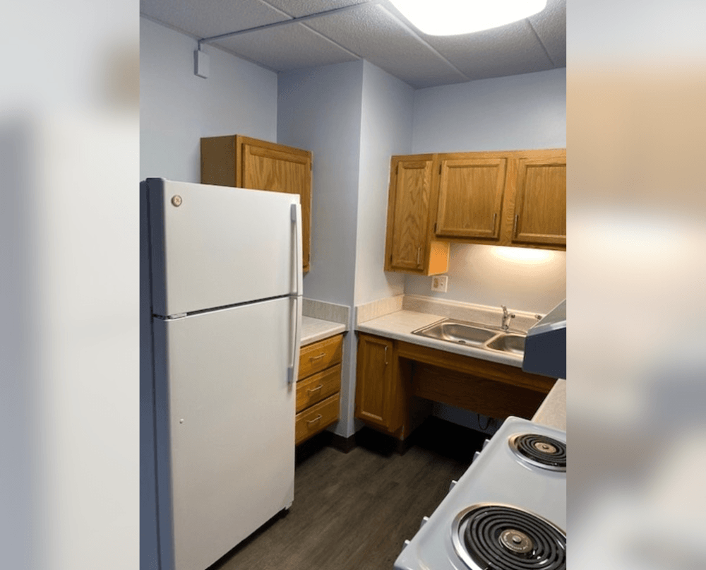 a kitchen with a white refrigerator and a stove