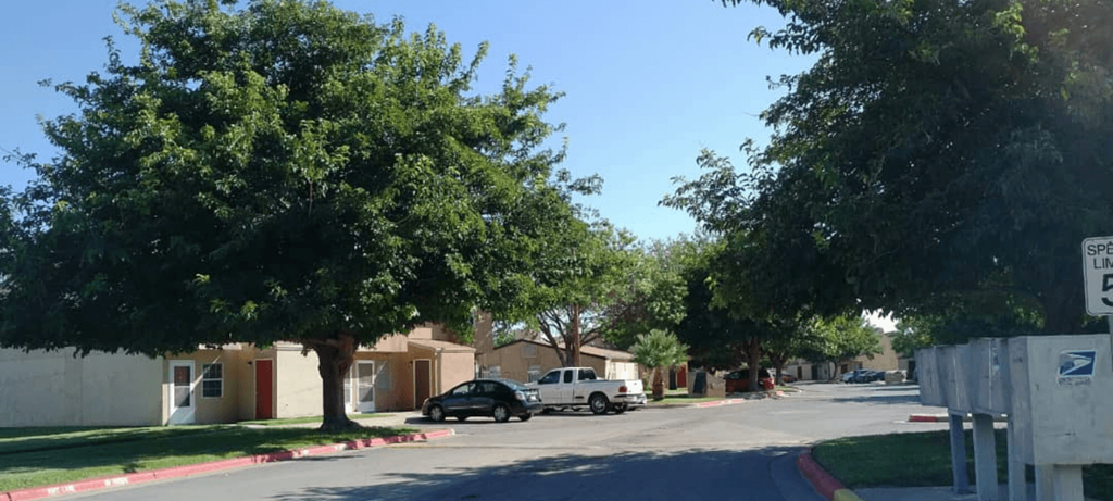 A black car is parked on the side of a street.