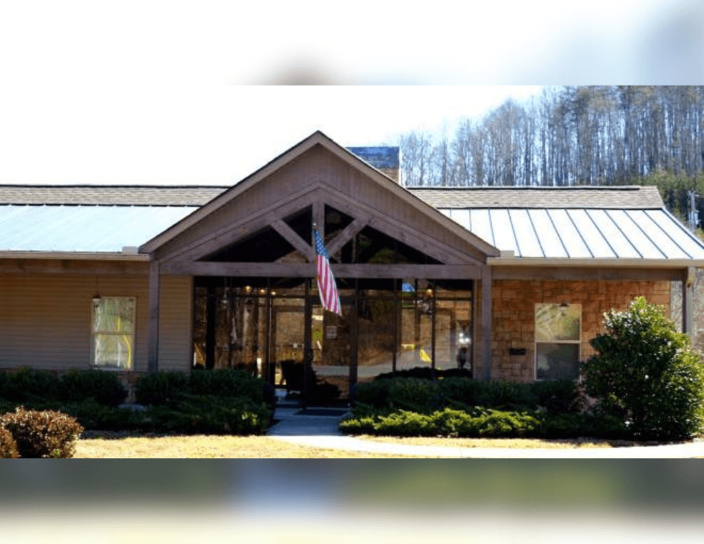 a view of the front of a brick building with an flag