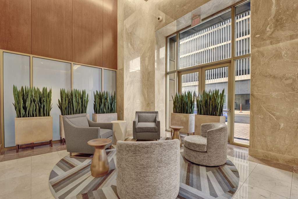 A room with a large window and a couch.