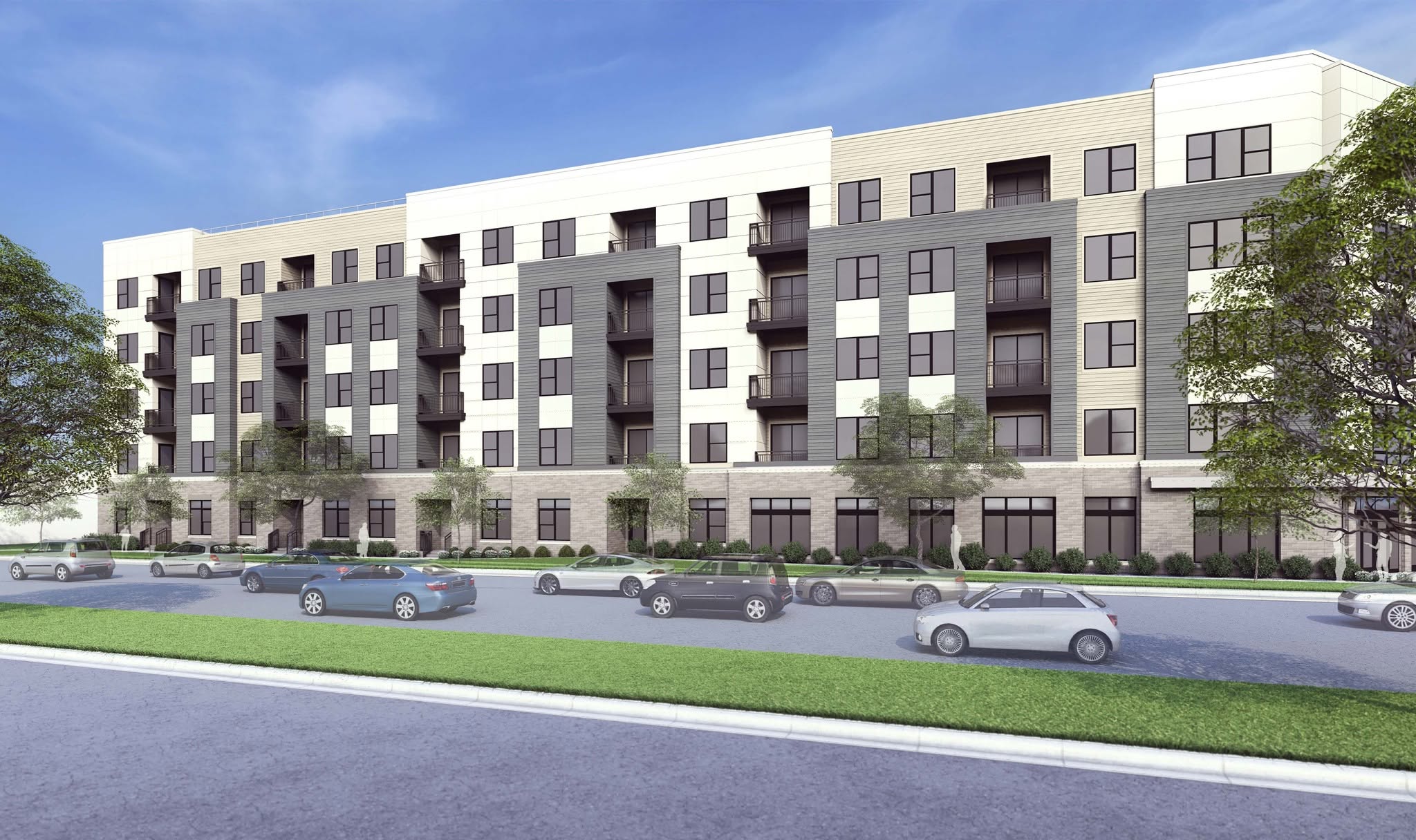 A modern apartment building with cars parked in front.