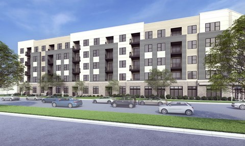 A modern apartment building with cars parked in front.