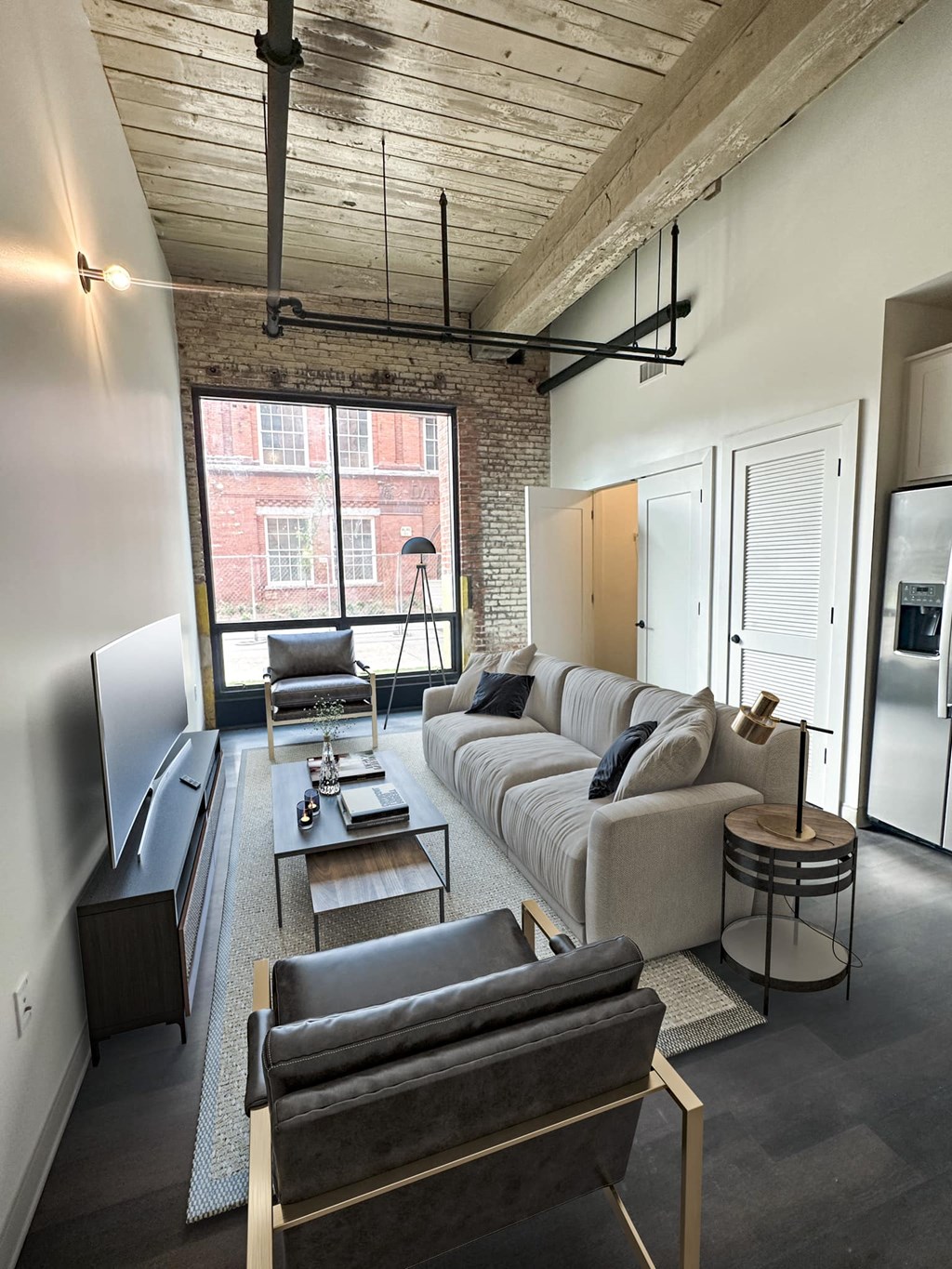 a living room filled with furniture and a large window at The Mill at Prattville, Prattville