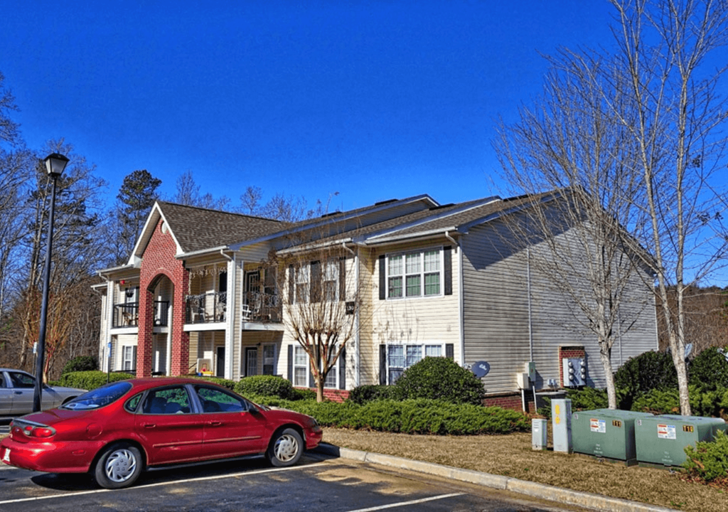 a red car parked in front of a house