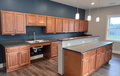 a kitchen with wooden cabinets and a sink and counters