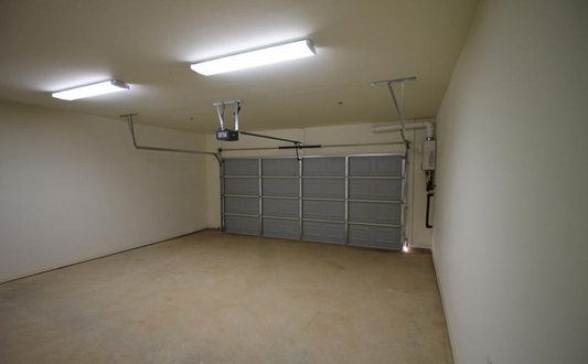 the inside of a garage with a garage door