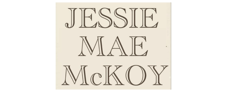 A white sign with black text that reads "Jessie Mae McKoy".