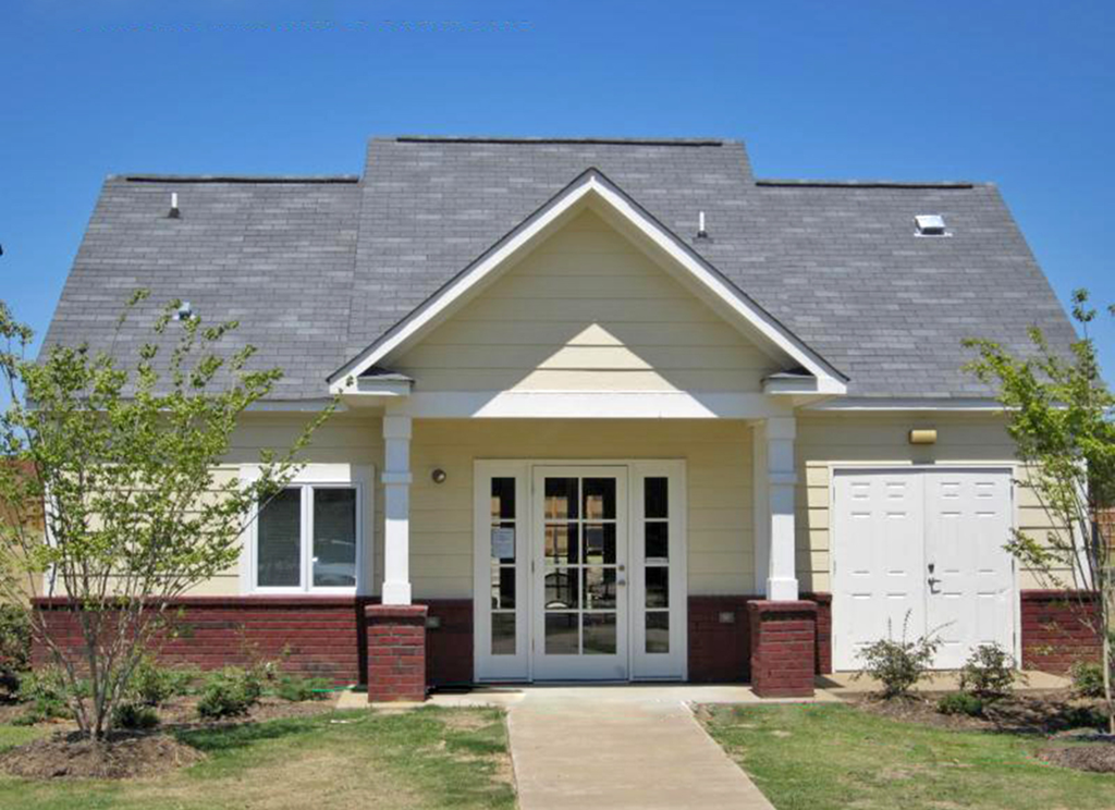 a house with a gray roof and white doors