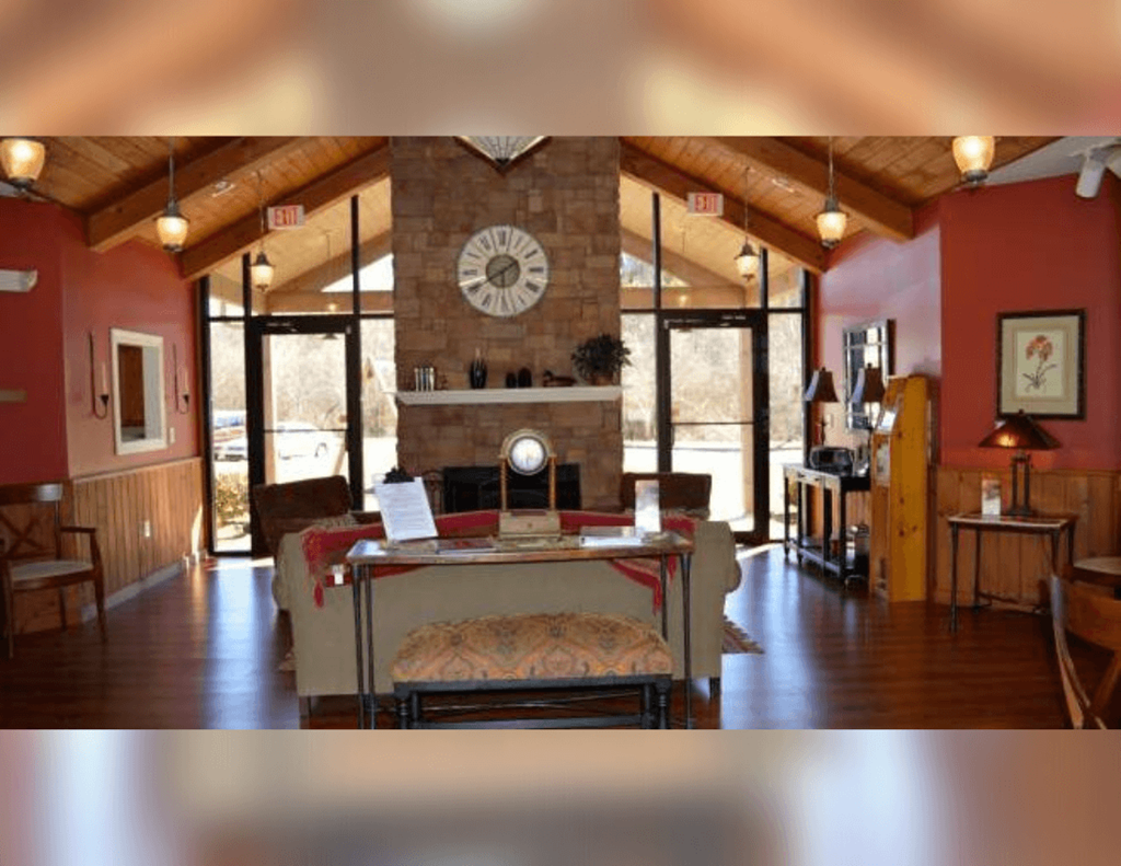 a living room with a fireplace and a clock on the wall