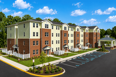 Apartment complex with a white picket fence and a driveway with the word "MANAGEMENT" painted on it.
