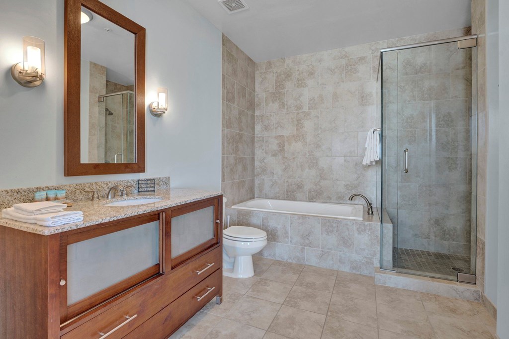 A bathroom with a toilet, sink, and shower.
