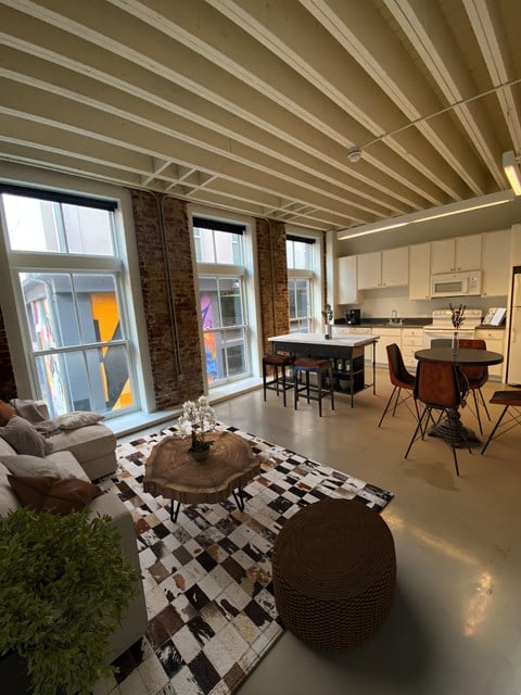 a living room and kitchen with a checkered floor at Lofts at Union Alley, Memphis