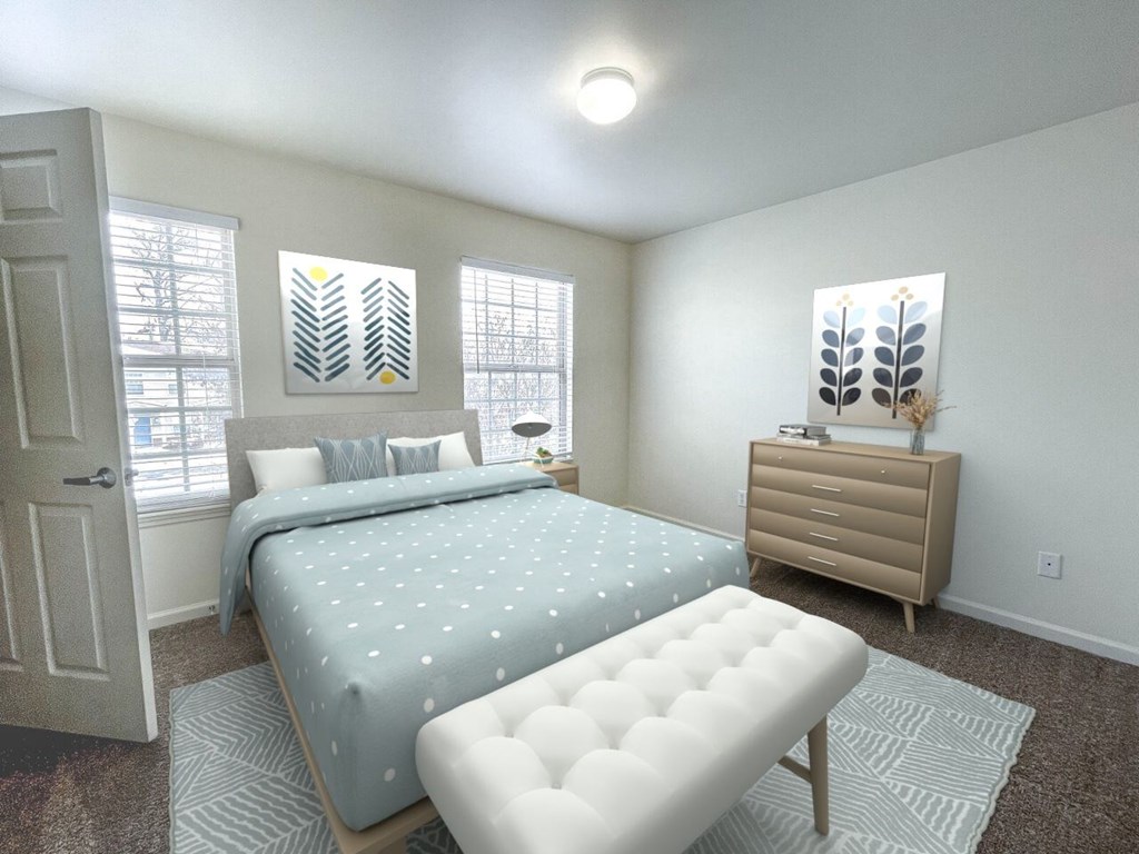 A bedroom with a bed, nightstand, and window.