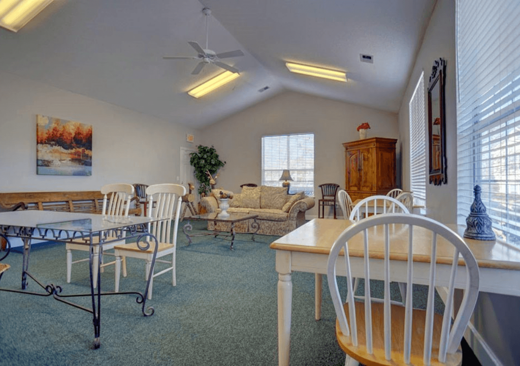 a living room with a table and chairs