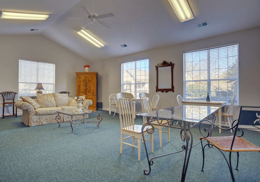 a living room and dining room with a table and chairs
