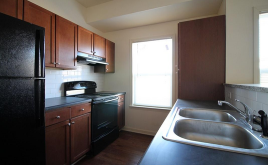 a kitchen with a sink a stove and a refrigerator