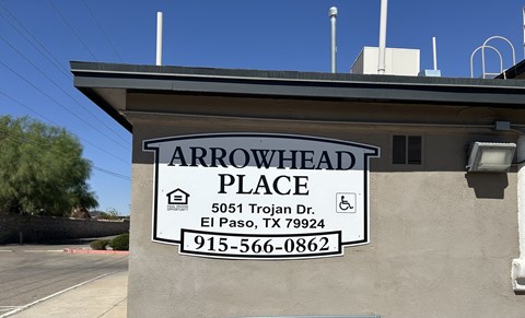 A sign for Arrowhead Place in El Paso, TX is displayed on a building.
