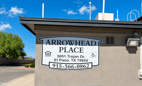 A sign for Arrowhead Place in El Paso, TX is displayed on a building.