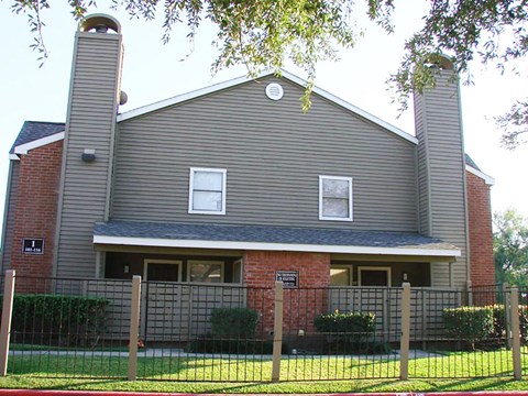 a large house with a fence in front of it
