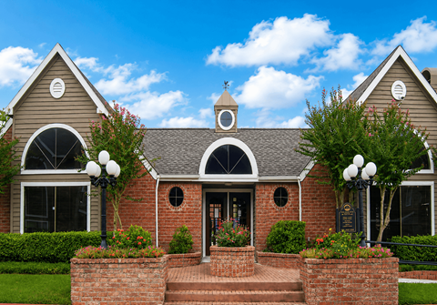 A house with a brick facade and a grey roof.