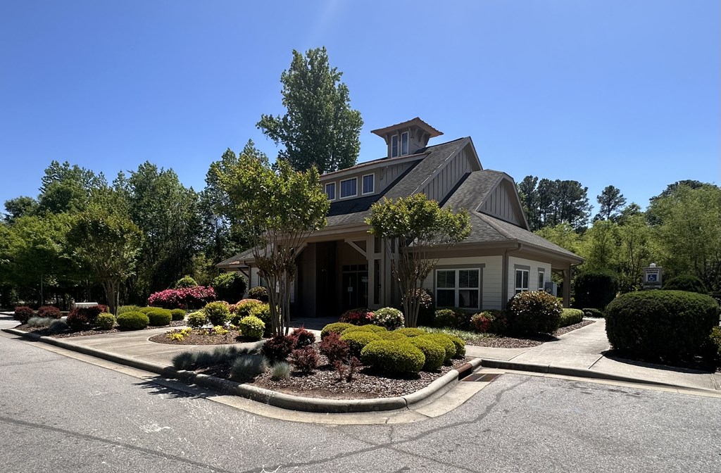 a house with a driveway and landscaping in front of it