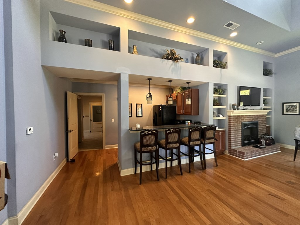 a living room with a fireplace and a table with chairs