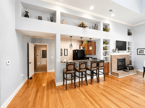 A modern living room with a fireplace and a dining table set up.