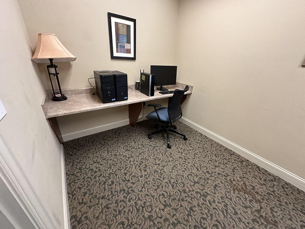 a small office with a desk and a computer