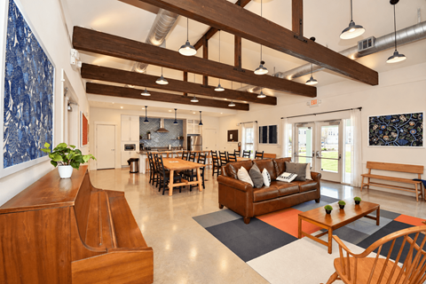 A clubhouse with a dining area and a couch.