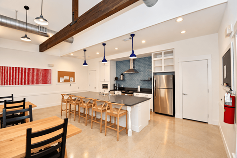 The community kitchen in the clubhouse with a large island and fridge